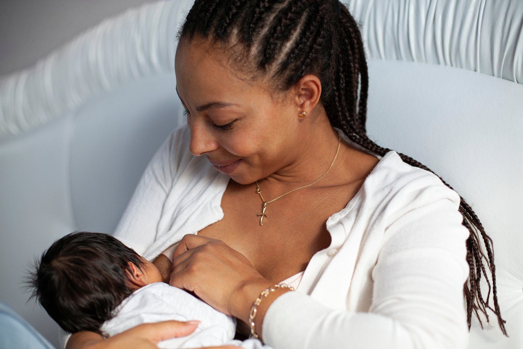 African American Woman Breastfeeding A Newborn Baby