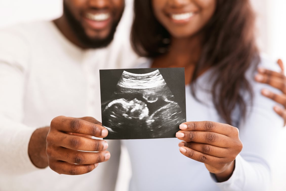 Happy Pregnant Couple Holding Ultrasound Scan of Baby